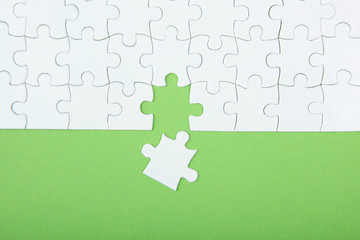 White puzzle on a colored background top view.