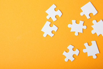 White puzzle on a colored background top view.
