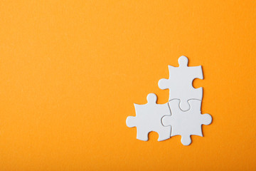 White puzzle on a colored background top view.