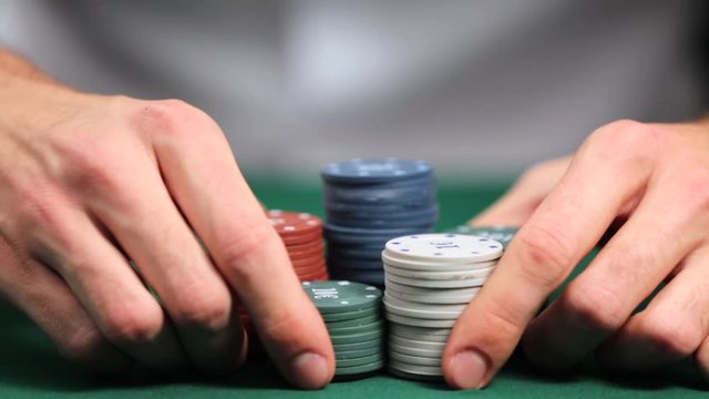 Man playing poker in casino, closeup