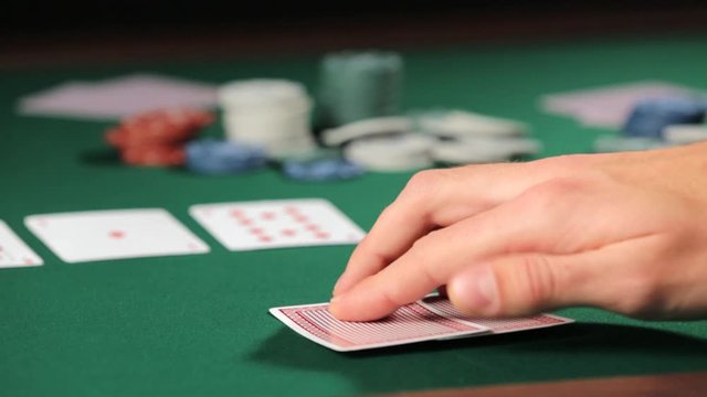 Man playing poker in casino, closeup