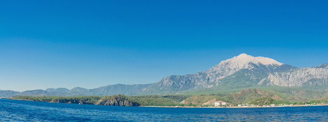 Fototapeta na wymiar Mountains on the sea in summer