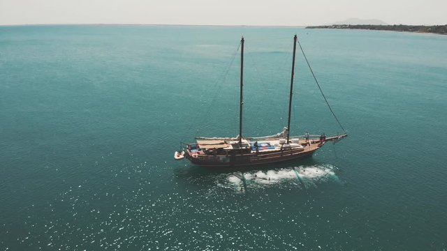 Aerial view of people jumping from a ship/barkentine/schooner