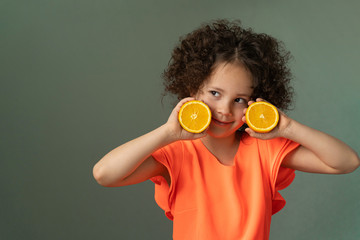 curly girl in an orange dress with an orange