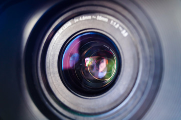 Close-up of camera lens with reflecting lights