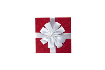 Red gift box with white color ribbon and bow isolated on white background top view close up. Selective soft focus. Text copy space. Holiday present concept