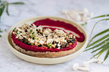 Toast with beetroot hummus, cheese and mushrooms