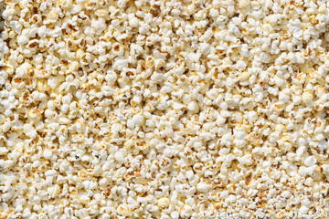 Large group of fresh cooked popcorn displayed for sale at a street food market, photographed with soft focus in warm yellow light, top view photo of healthy food photographed with soft focus