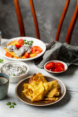 Crepes with mushrooms sauce on white table
