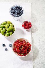 Ripe blueberry, red currants and raspberry in  bowls