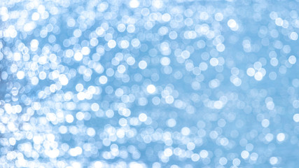 Abstract light blue background with white bokeh_