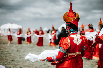Photo of young beautiful women wearing in traditional national mongolian kalmykian dresses in the festival.