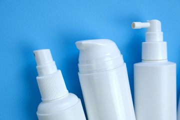 Disinfectant Bottle Set. Hand disinfection concept. White plastic bottles on a  blue background. Hygiene and health concept. Hygiene during the epidemic of coronavirus.Cosmetic bottles Mockup.