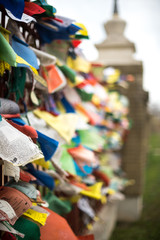 Photo of buddhist prayer flags on the wall waving on the wind in old temple