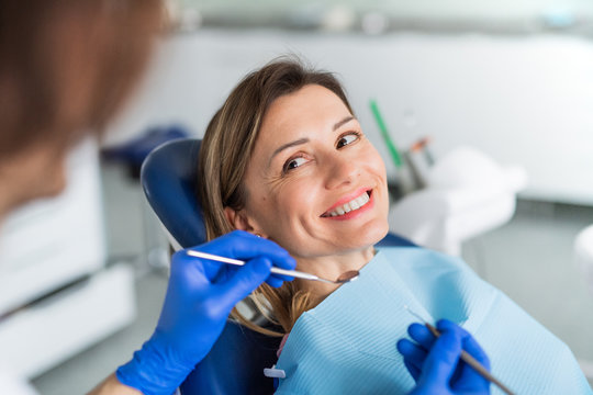 A woman has a dental check-up in dentist surgery. - Powered by Adobe