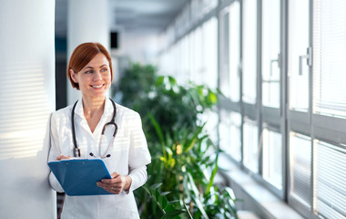 Portrait of woman doctor standing in hospital. Copy space.
