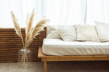 Modern interior design of pampas grass and a cozy sofa