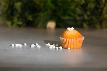 Delicious looking muffin with sugar pearls on a table