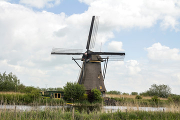 Fototapeta na wymiar Netherlands rural lanscape with windmills at famous tourist site Kinderdijk, Rotterdam, in Holland. Old Dutch village Kinderdijk, UNESCO world heritage site. 