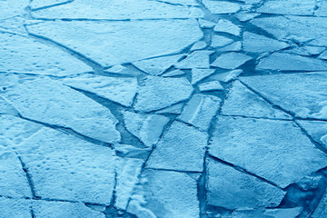 Top view of cracked blue ice, texture of ice
