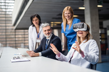 Doctors and pharmaceutical sales representative using VR goggles.