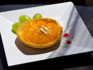 Dessert cakes on a white plate. Tartlet with fruits. Dessert.