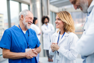 Group of doctors standing on medical conference, talking.