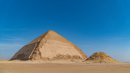 The Bent Pyramid is an ancient Egyptian pyramid located at the royal necropolis of Dahshur,...