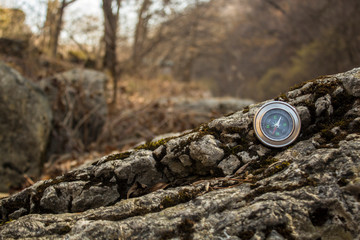 compass on a stone covered with moss