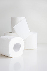 Rolls of toilet paper on light gray background