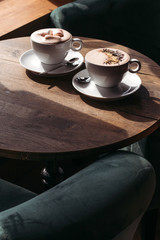 Cocoa in large white cup on table in cafe. Cocoa with marshmallows, peppers. Place for text.