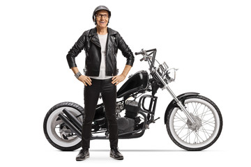 Naklejka premium Elderly male biker standing next to a custom motorbike