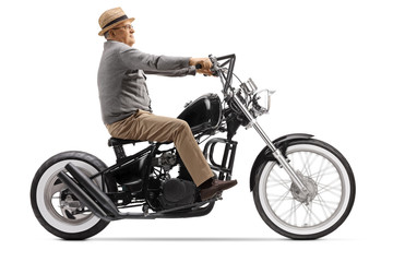 Fototapeta na wymiar Senior gentleman riding a chopper motorbike