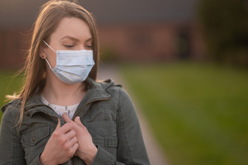 Coronavirus, masked girl on an empty street in USA. The title is about an outbreak of a coronavirus...