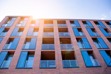 Modern apartment building exterior concept. Sunshine sun flare.  