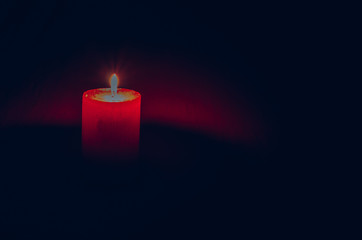 burial concept with burning candle against black background