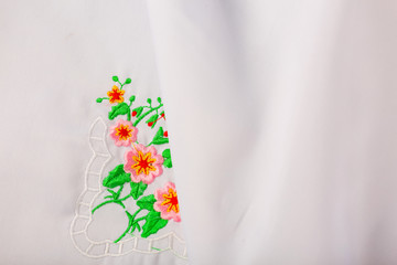 White tablecloth for the dining table. Tablecloth embroidery, close up