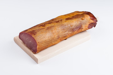 Delicious smoked meat on a wooden board isolated on white background.Copy space