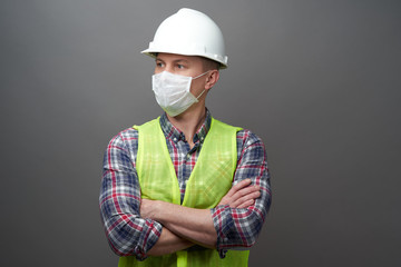 Worker man wearing hygienic mask and protective hard hat.