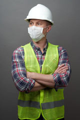 Worker man wearing hygienic mask and protective hard hat.