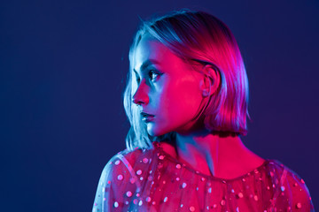 Mysterious hipster teenager. Portrait of millennial pretty girl with short hairstyle with neon...