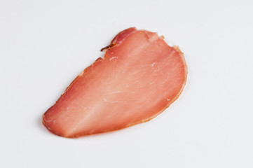 Delicious smoked meat on a wooden board isolated on white background.Copy space