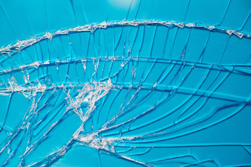 Blue background through the broken window glass.