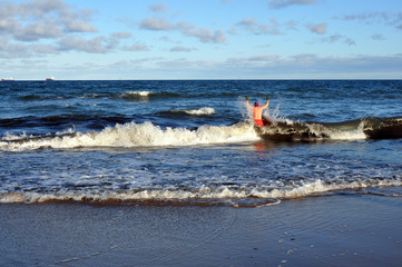 People bathe in the cold Baltic sea in winter, harden their bodies so that they don't get sick and be energetic.