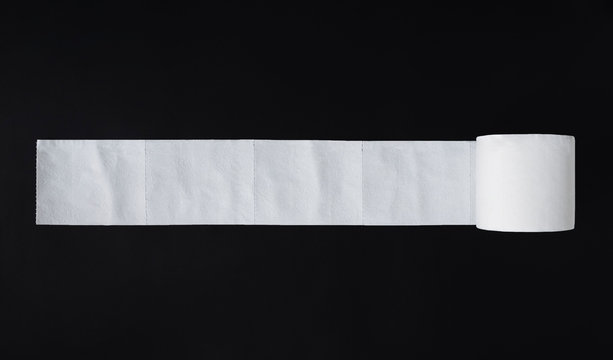 Top view of unrolled toilet paper at black background