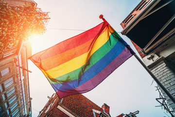 Rainbow LGBT Pride Flag blowing on wind, close up.