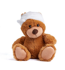 teddy bear with a bandaged head in a white medical bandage on a white background