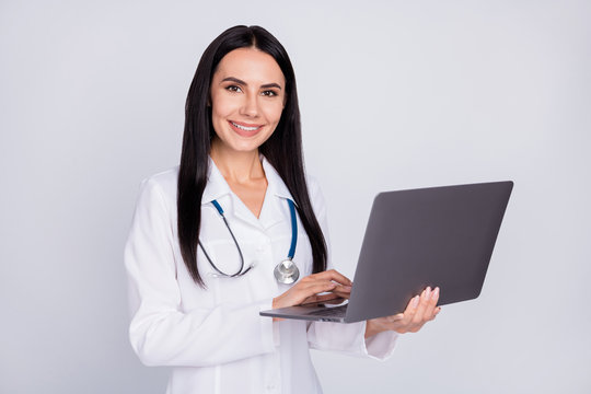 Photo of professional doc lady working with modern technology notebook laptop writing notes patient prescription wear stethoscope white lab coat isolated grey color background
