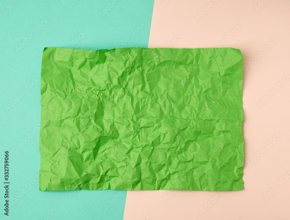 Poster empty crumpled green rectangular sheet of paper a4 on a color background