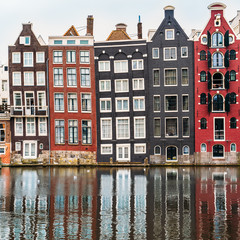 Fototapeta premium Famous dancing houses and buildings in Amsterdam with reflection in canal water.